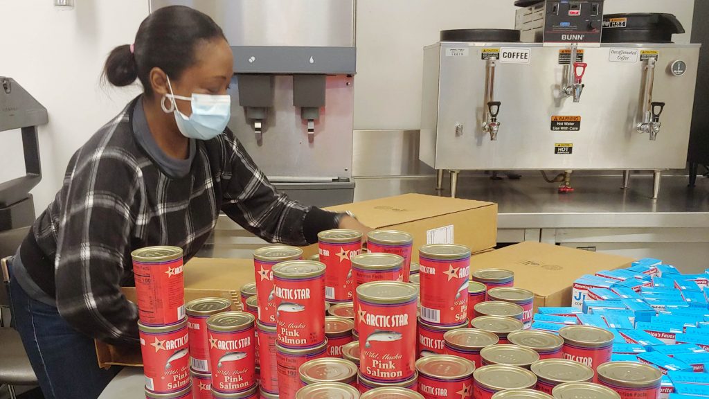 News 17 GMHC volunteer preparing food packages for clients.